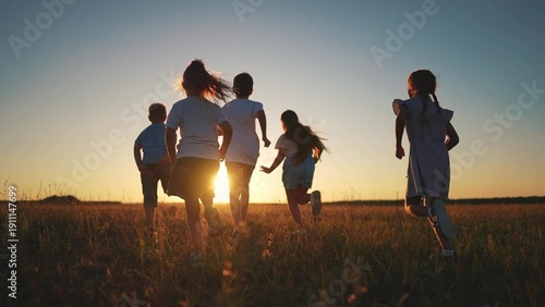 children running in the park silhouette. people in park. children a kid together run in park at sunset silhouette. group of lifestyle children run. happy family and little baby child summer