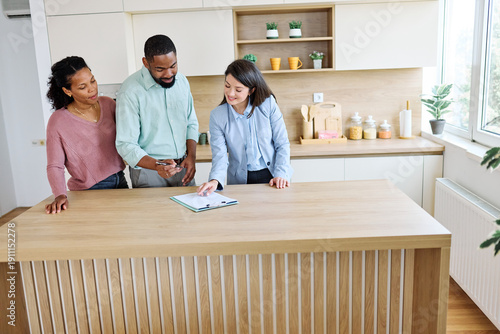 Photos Female Real Estate Agent Selling Modern Apartment To His Young Clients , a coupl
