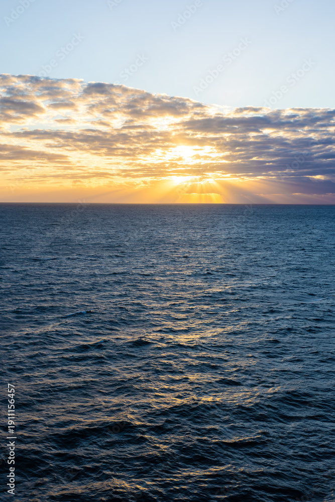 Fototapeta premium Calm ocean water skyline at sunset tranquil seascape vertical photo