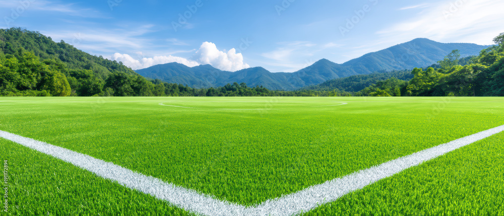 Obraz premium Green grass sports field white line mountain blue sky cloud outdoor nature landscape sunny day grass field athletic field recreation open space horizon summer fresh vibrant natural environment