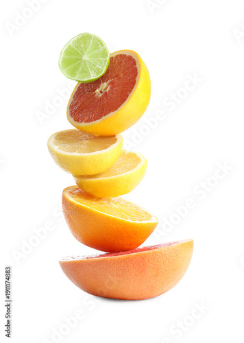 Stack of different fresh citrus fruits isolated on white