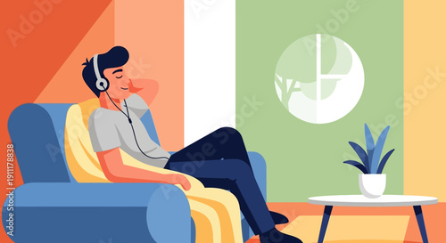 Man relaxing on blue sofa listening to music with headphones in a cozy living room