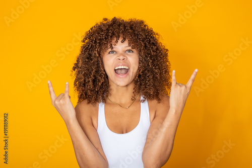 Valokuva young woman with afro hair and rebellious expression isolated on background