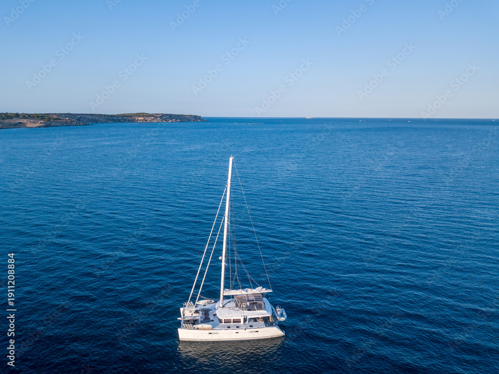 Fototapeta premium Aerial View of L-Aħrax with Sailboat, Malta