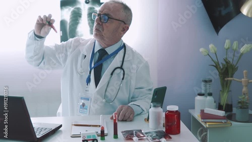 Elderly medical professional in his office explaining test results to a patient via video call