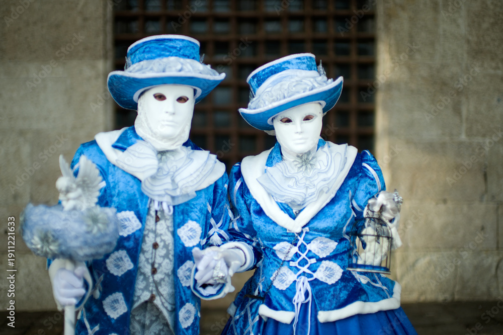 Obraz premium Venice, Italy - February 9, 2026 - People dressed in masks for the Venice Carnival have their photos taken by tourists