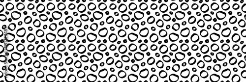Hand-drawn seamless pattern with irregular black circles and dots on white background. Perfect for wrapping paper, textile print, or bohemian design projects.