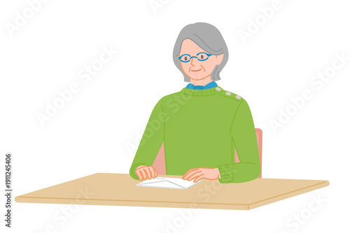 Senior woman checking envelope placed on desk