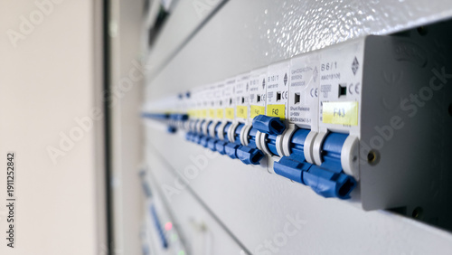 Quadro su tela Row of blue circuit breakers inside electrical distribution panel