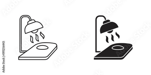 Simple black and white line art illustration of induction cooktops with water droplets