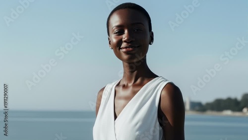 Wallpaper Mural Elegant Young Black Woman Smiling Outdoors Near the Sea, Wearing a White Dress Torontodigital.ca
