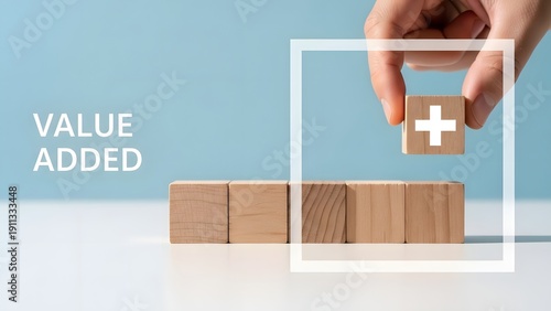 Hand adding wooden block with plus sign to row value added