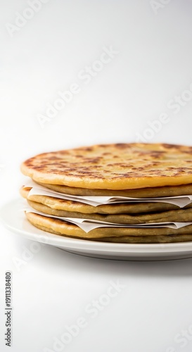 Three Glossy Layered Aloo Parathas Brushed with Ghee, Isolated Studio Shot.