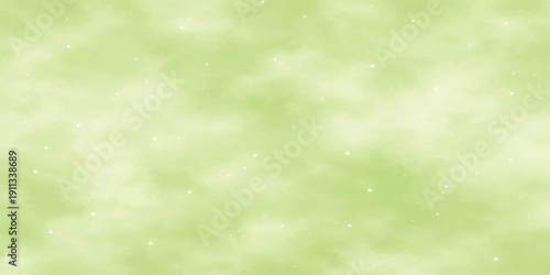 A soft abstract green bokeh background features bright sunny light blurring over a spring meadow garden to create a shiny nature texture design for a summer season wallpaper