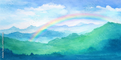A beautiful summer rainbow arcs across the blue sky over a green mountain landscape with clouds and sunlit meadows after a storm