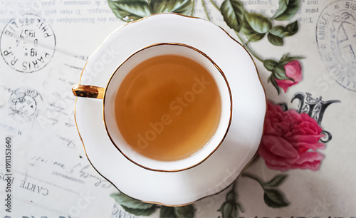 Valokuva Elegant Tea Cup Top View on Vintage Floral Background, Cozy Tea Time