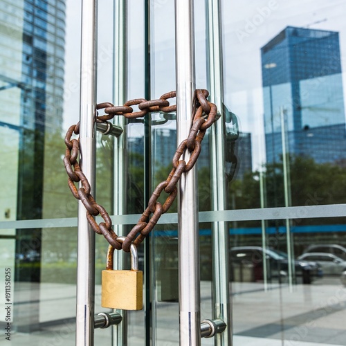 Rusty Chain and Padlock Securing Glass Entrance Doors