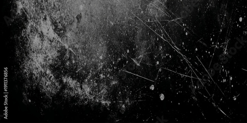 A heavily distressed and scratched black surface displaying a worn texture with prominent lines and smudges