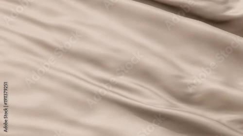 Soft beige fabric waves forming elegant folds and shadows, creating a calm neutral aesthetic perfect for minimal design, fashion themes, or texture backgrounds.