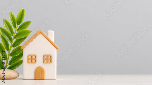 Charming miniature wooden house model with a fresh green plant, symbolizing sustainable living, eco-friendly home ownership, and future property investments