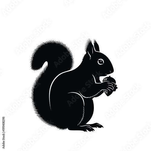 Black squirrel holding a nut in its paws.
