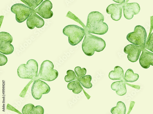 Seamless pattern with green clover on a light green background