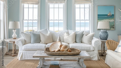 Serene coastal living room with a white sofa, ocean-inspired decor, and large windows overlooking the sea, creating a relaxing atmosphere.