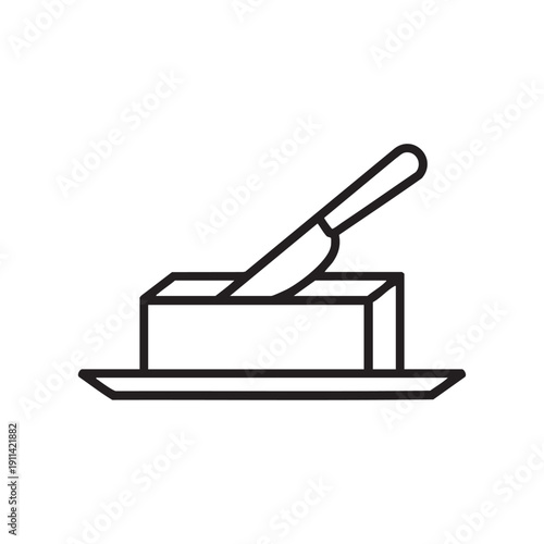 A trowel resting on a rectangular brick placed on a flat surface, viewed from a slight angle, illustrating a simple construction tool in a minimalist setting