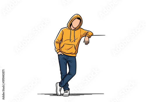 Young man in yellow hoodie leaning against a wall.