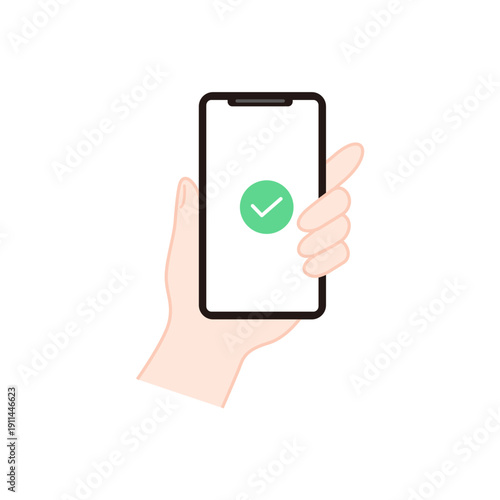 手に持ったスマホに表示されたチェックマークの完了アイコン 