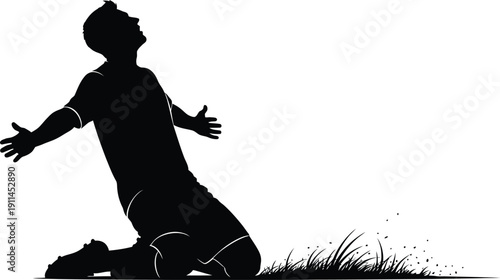 Silhouette of a man kneeling in prayer or praise on grass with arms outstretched