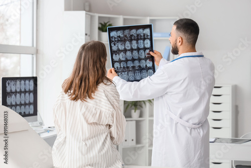 Male doctor showing MRI sca...
