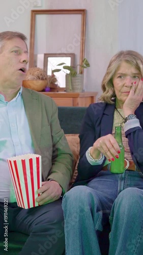 Senior couple watching an exciting sports game that lose and getting angry