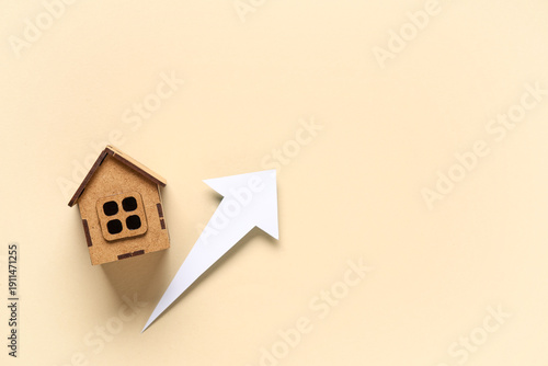 Model of house and arrow on...