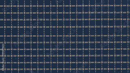 A close up view showcases a textured navy blue fabric with a repeating grid pattern of lighter beige or tan woven lines high quality professional detailed