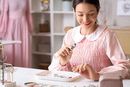 Female jewelry designer exa...