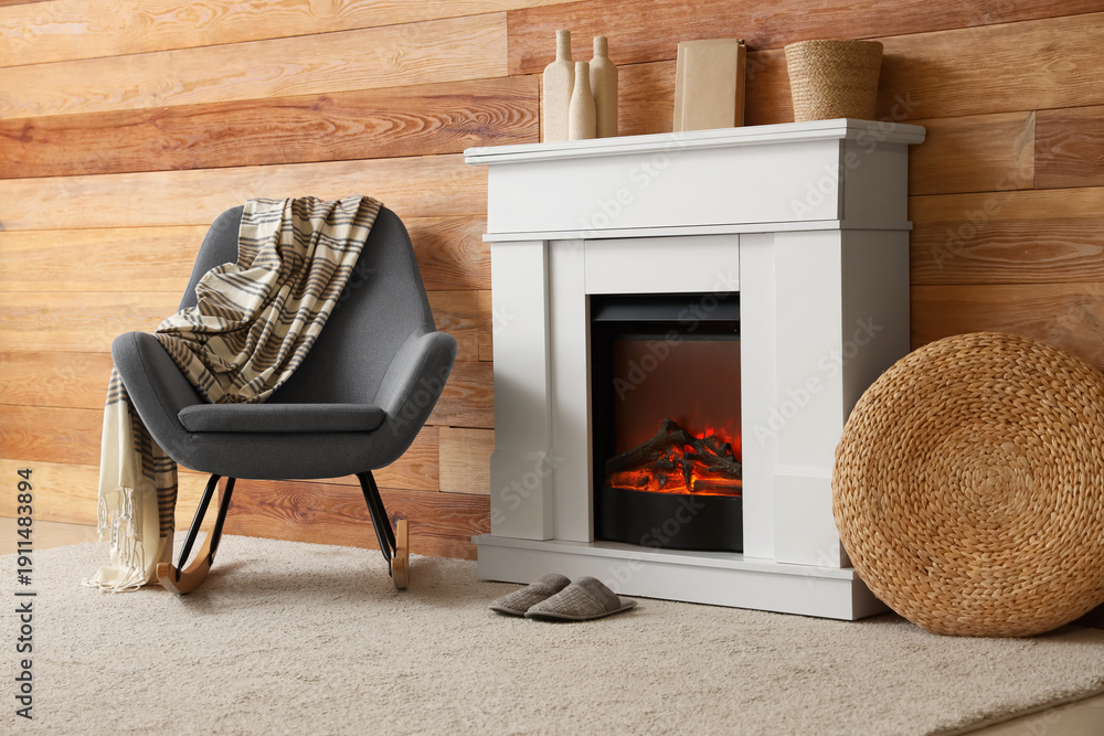 Naklejka premium Cozy interior of living room with fireplace, armchair and slippers