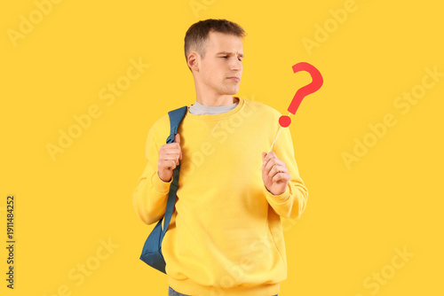 Male student with paper que...