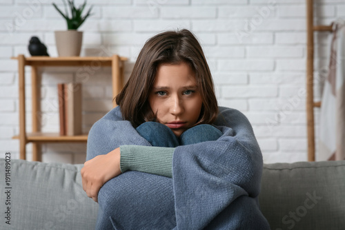 Depressed young woman wrapp...