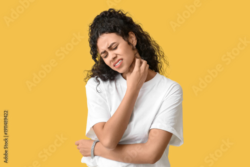 Εκτύπωση καμβά Young African-American woman suffering from skin allergy on yellow background