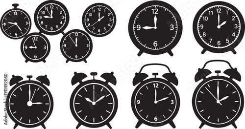 Collection of various black alarm clocks and round timers