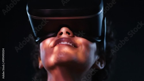 Person wearing virtual reality headset in dark environment with blue glow