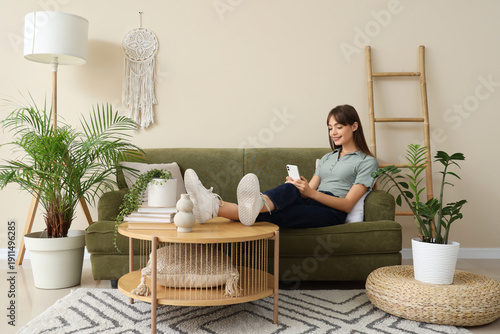 Young woman using mobile ph...
