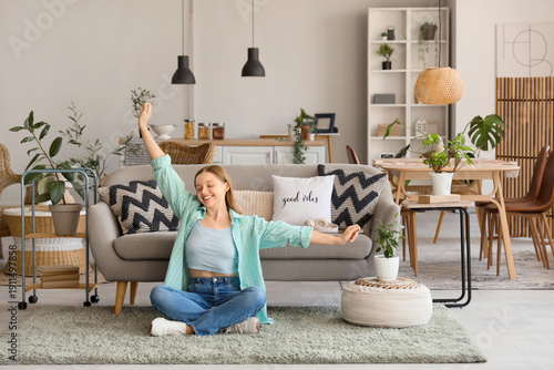 Happy young woman sitting o...