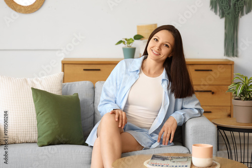 Young woman sitting on soft...