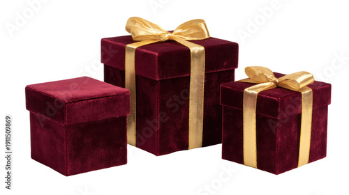 Three red velvet gift boxes with gold ribbons on transparent background