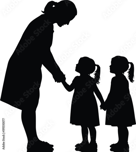 Silhouette of a woman and two young girls holding hands