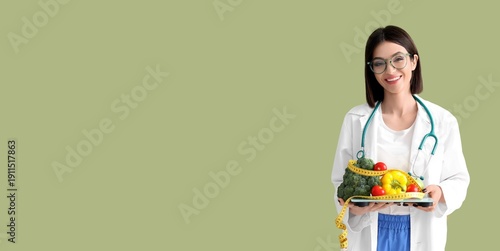 Female nutritionist holding...