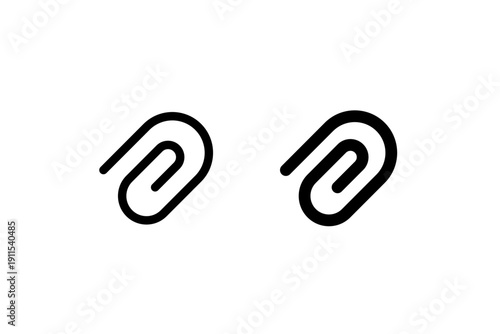 Pair of black metal paperclips on white background.