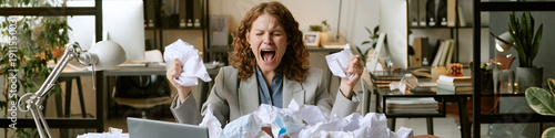 Canvastavla Caucasian young adult woman sitting at desk screaming while holding crumpled pap